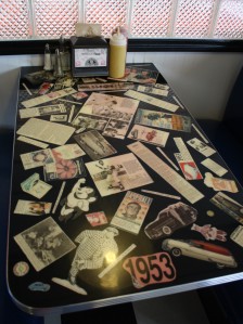 Each table is decorated with clippings and photos from a certain year.