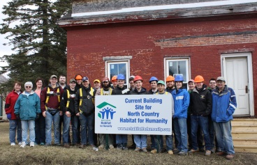 Members of North Country Habitat for Humanity are joined by volunteers from Clarkson University at the 26 Willow St. site in Malone.